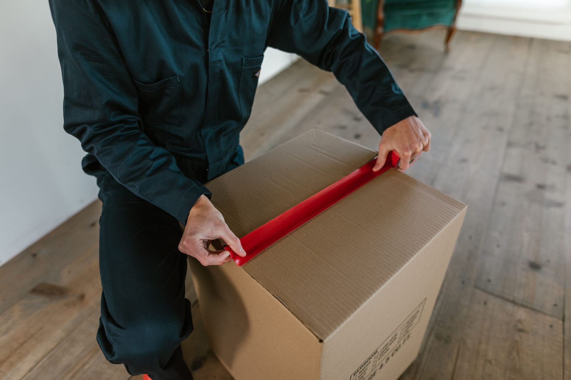 Hands pressing a sealing strip along the edge of a panel