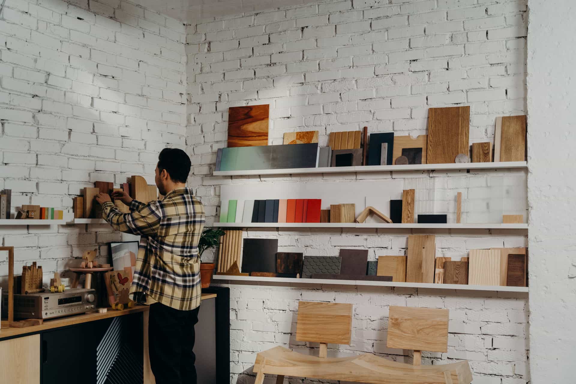 A person cutting and assembling plywood on a workbench in a workshop