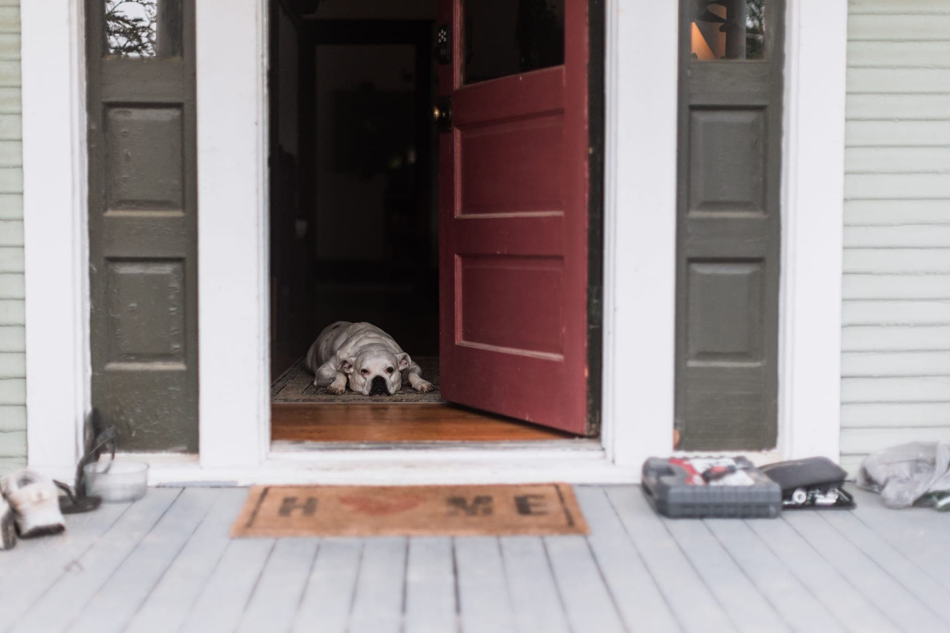An open exterior doorway with the threshold visible between the porch and the interior floor