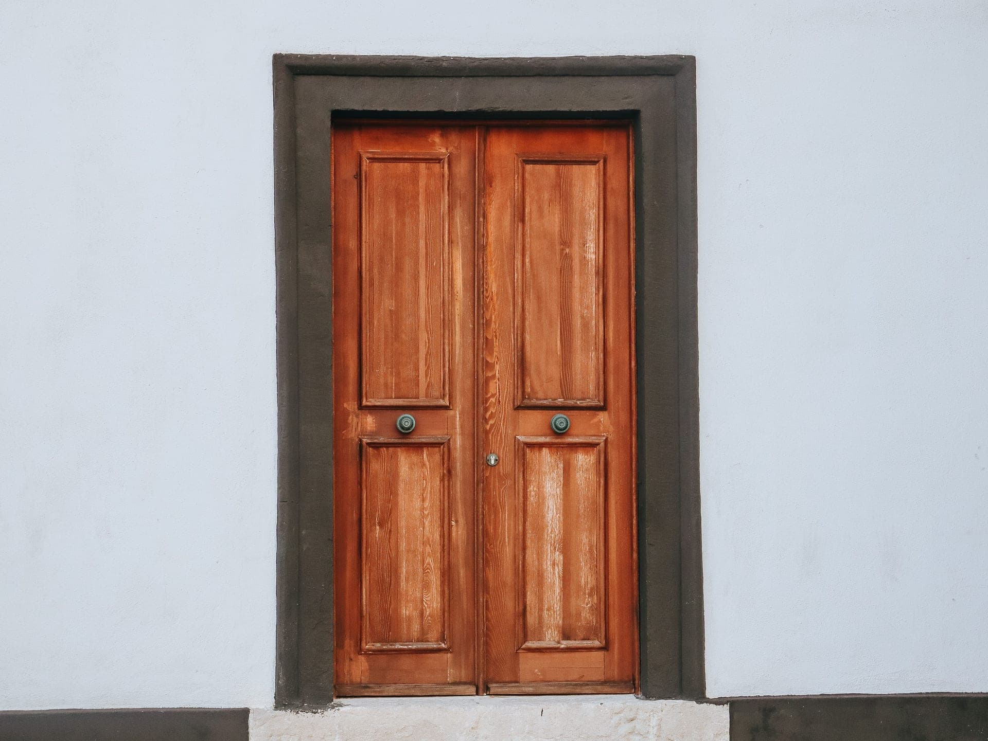 A wooden door and its frame seen close up