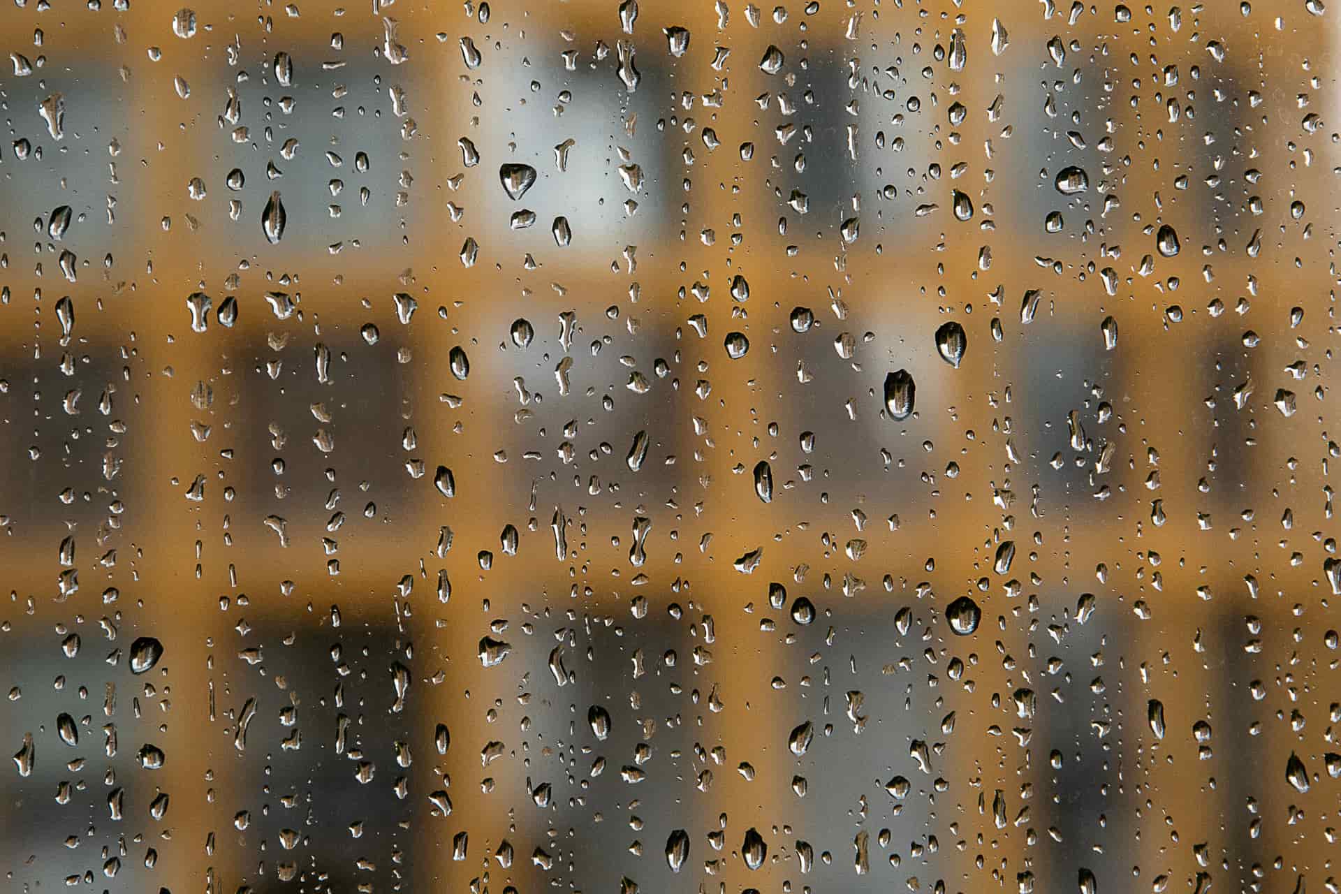 Shrink film catching the light across an old single-pane window on a frosty morning